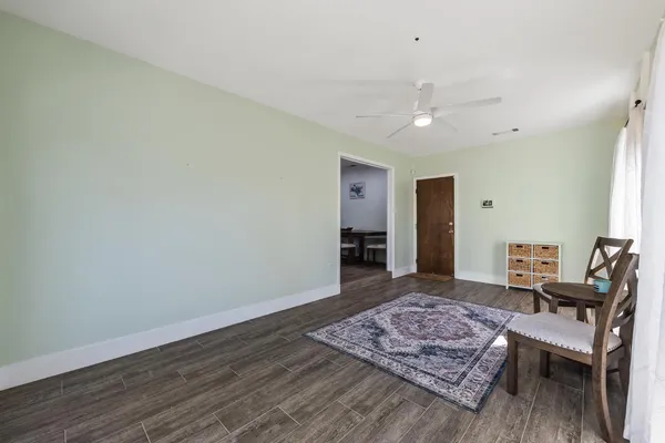 a living room with furniture rug and wooden floor