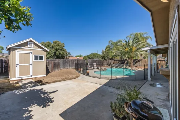 a view of a house with backyard and sitting area
