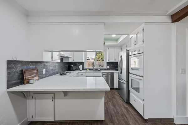 a kitchen with stainless steel appliances a sink and a refrigerator