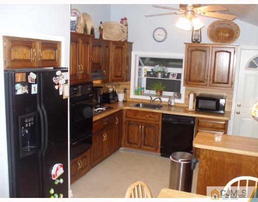 81 Westminster Road Colonia, NJ 07067 - Photo 2 of 9 a kitchen with granite countertop a refrigerator stove top oven and sink