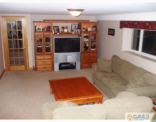 81 Westminster Road Colonia, NJ 07067 - Photo 5 of 9 a living room with furniture and a flat screen tv