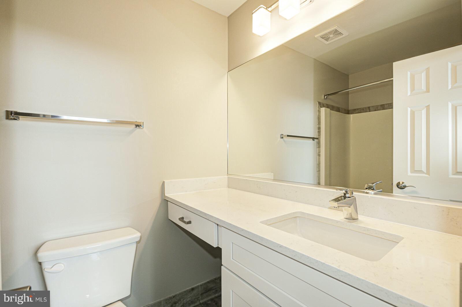 3002 South Glebe Road Arlington, VA 22206 - Photo 22 of 31 a bathroom with a sink a toilet and a mirror