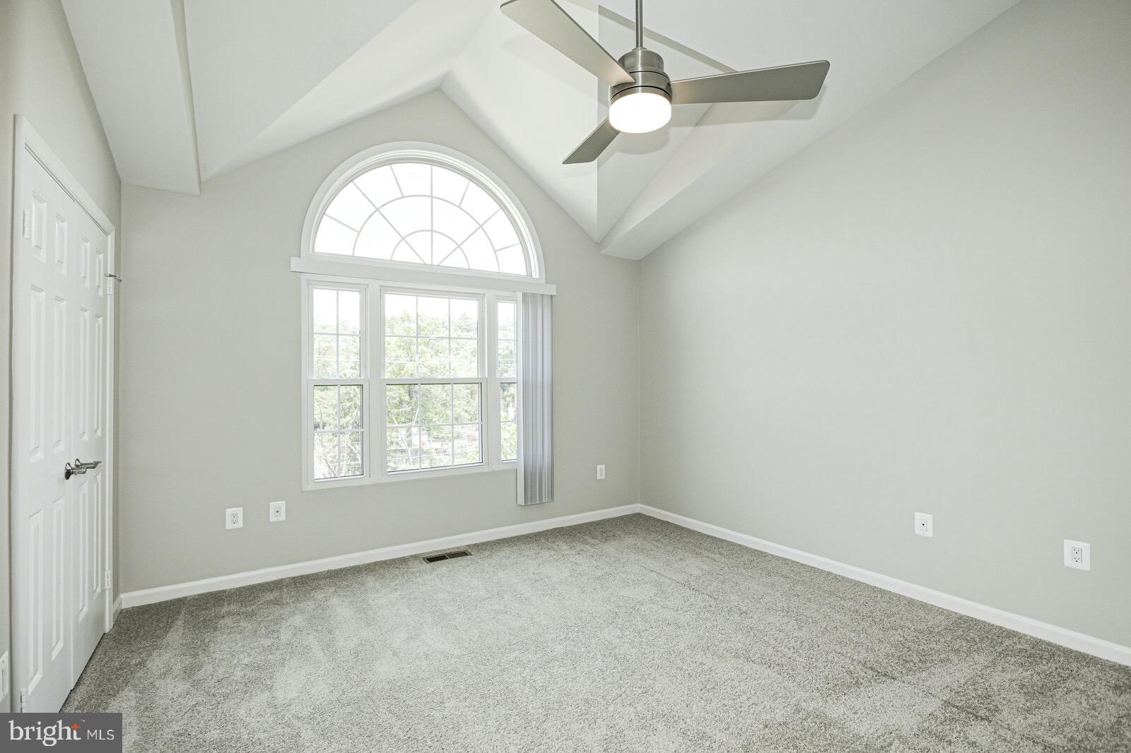 3002 South Glebe Road Arlington, VA 22206 - Photo 24 of 31 an empty room with a window and a chandelier
