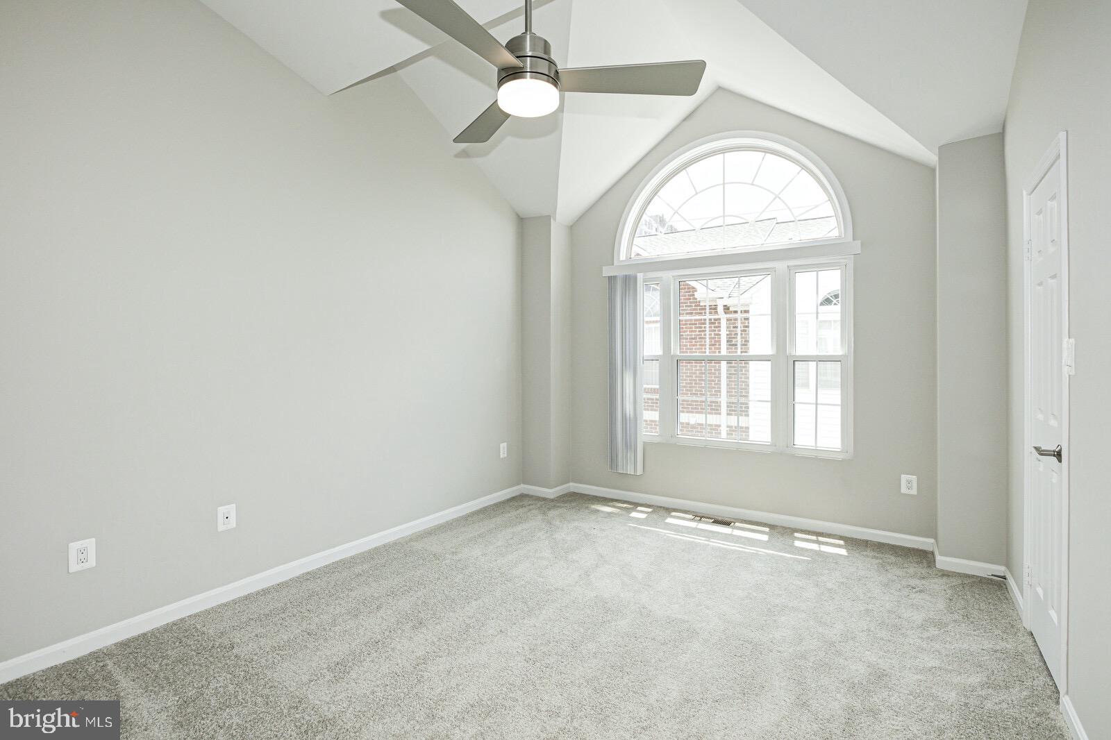 3002 South Glebe Road Arlington, VA 22206 - Photo 26 of 31 an empty room with a chandelier fan and windows