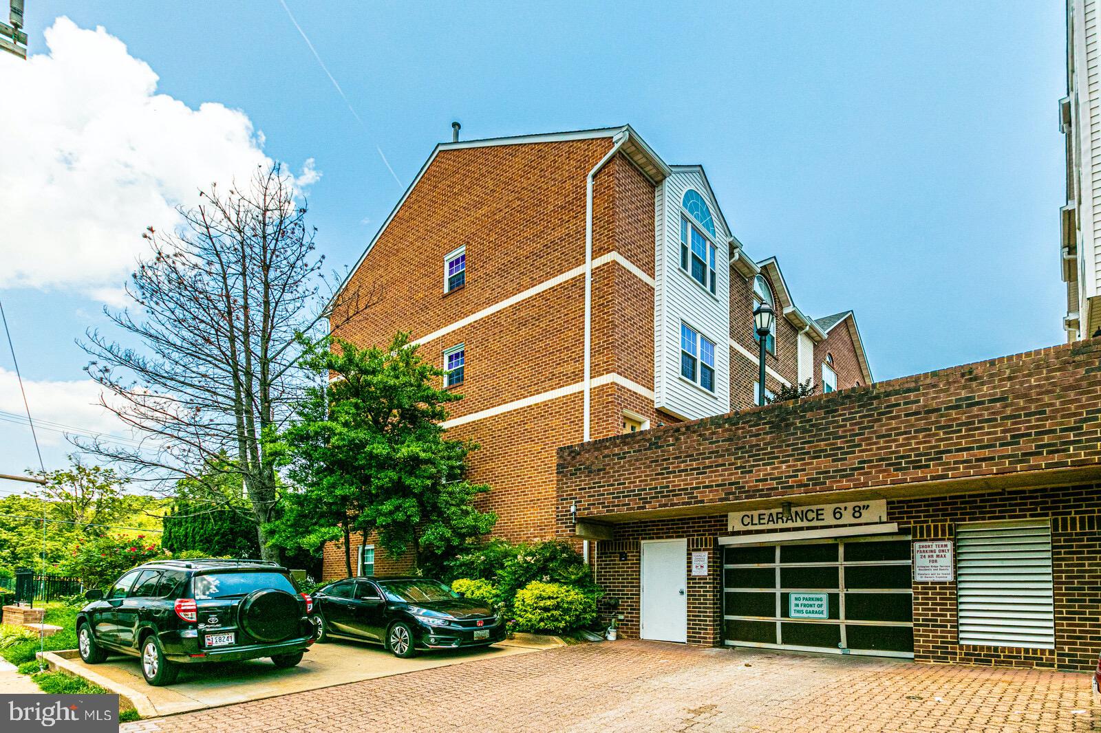 3002 South Glebe Road Arlington, VA 22206 - Photo 30 of 31 a front view of a house with a yard and potted plants