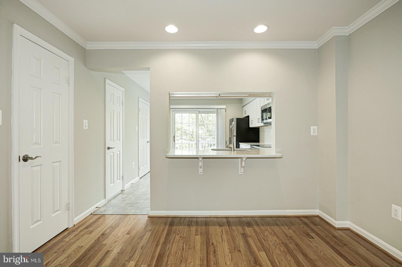 3002 South Glebe Road Arlington, VA 22206 - Photo 6 of 31 a view of an empty room with wooden floor and a window
