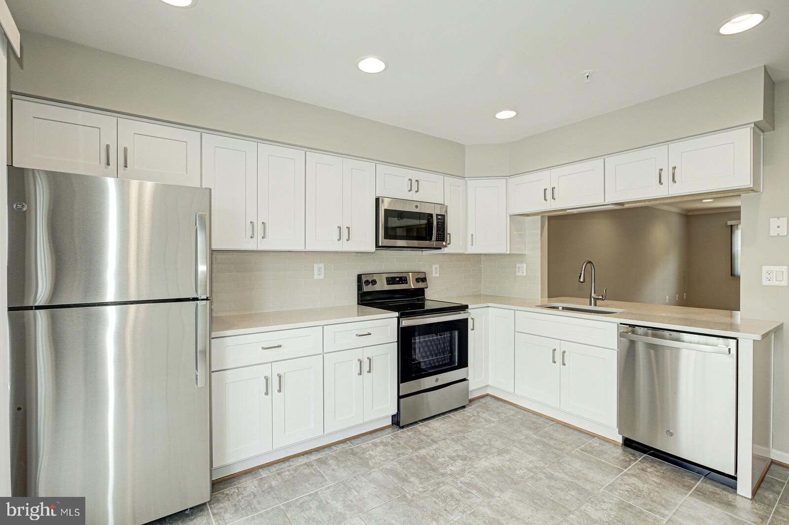 3002 South Glebe Road Arlington, VA 22206 - Photo 7 of 31 a kitchen with stainless steel appliances white cabinets and a refrigerator