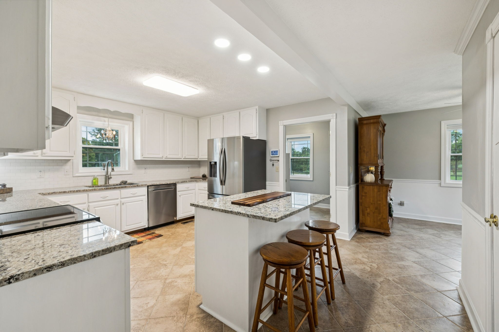 106 Highland Street Hohenwald, TN 38462 - Photo 15 of 85 a kitchen with granite countertop cabinets and refrigerator