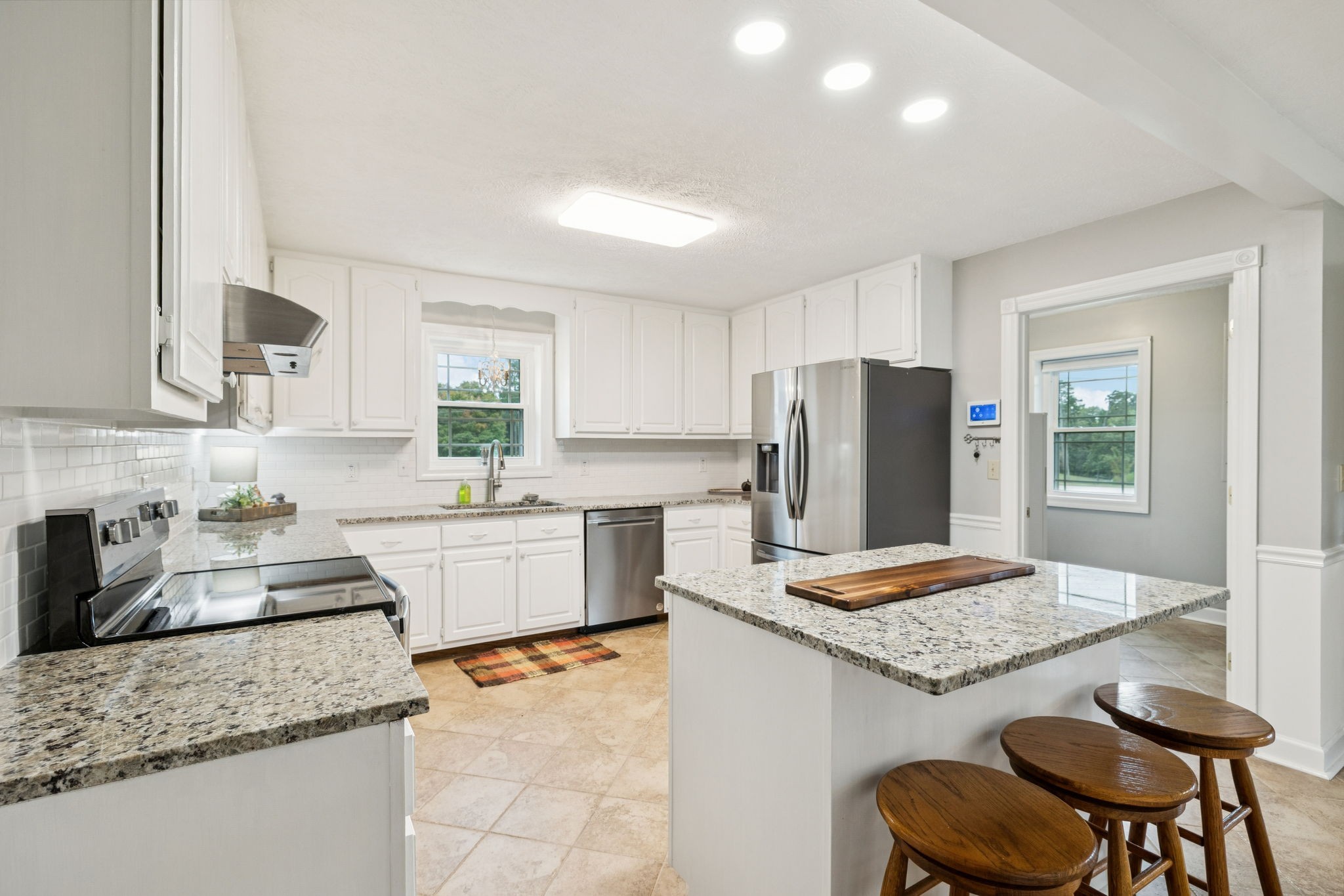 106 Highland Street Hohenwald, TN 38462 - Photo 16 of 85 a kitchen with granite countertop kitchen island sink stove and refrigerator