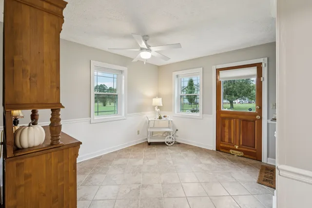a bathroom with a granite countertop toilet a sink and a mirror