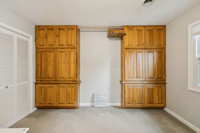 a backyard of a house with lots of green space and fountain