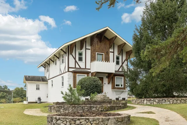 a front view of a house with garden