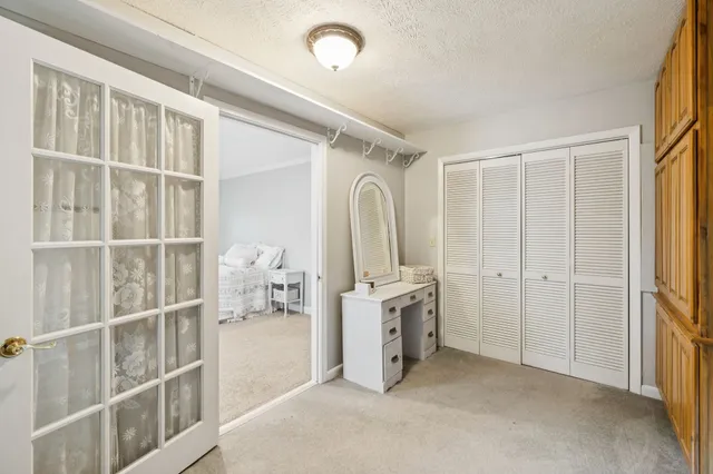 a backyard of a house with table and chairs