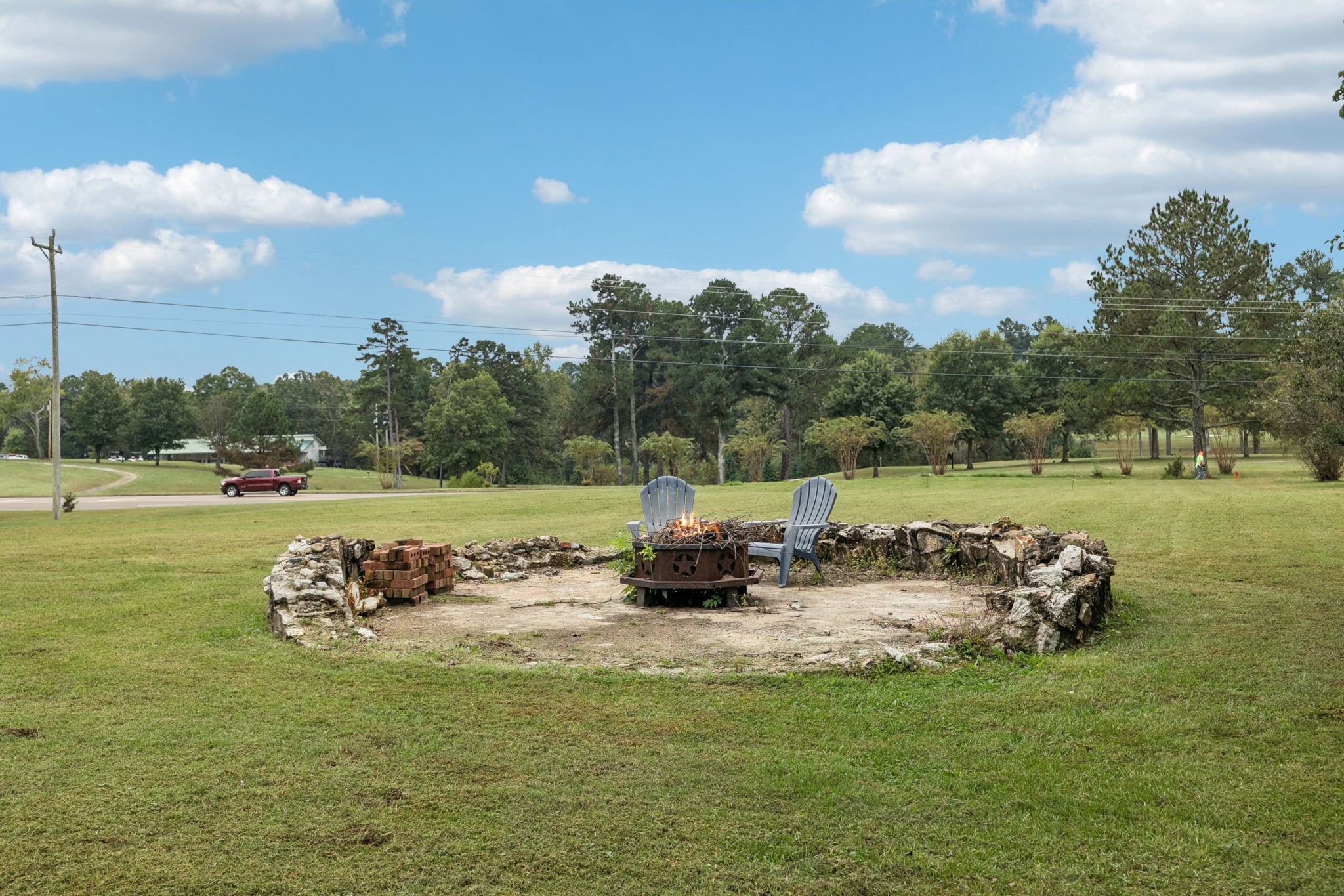 106 Highland Street Hohenwald, TN 38462 - Photo 46 of 85 a backyard of a house with lots of green space and fountain