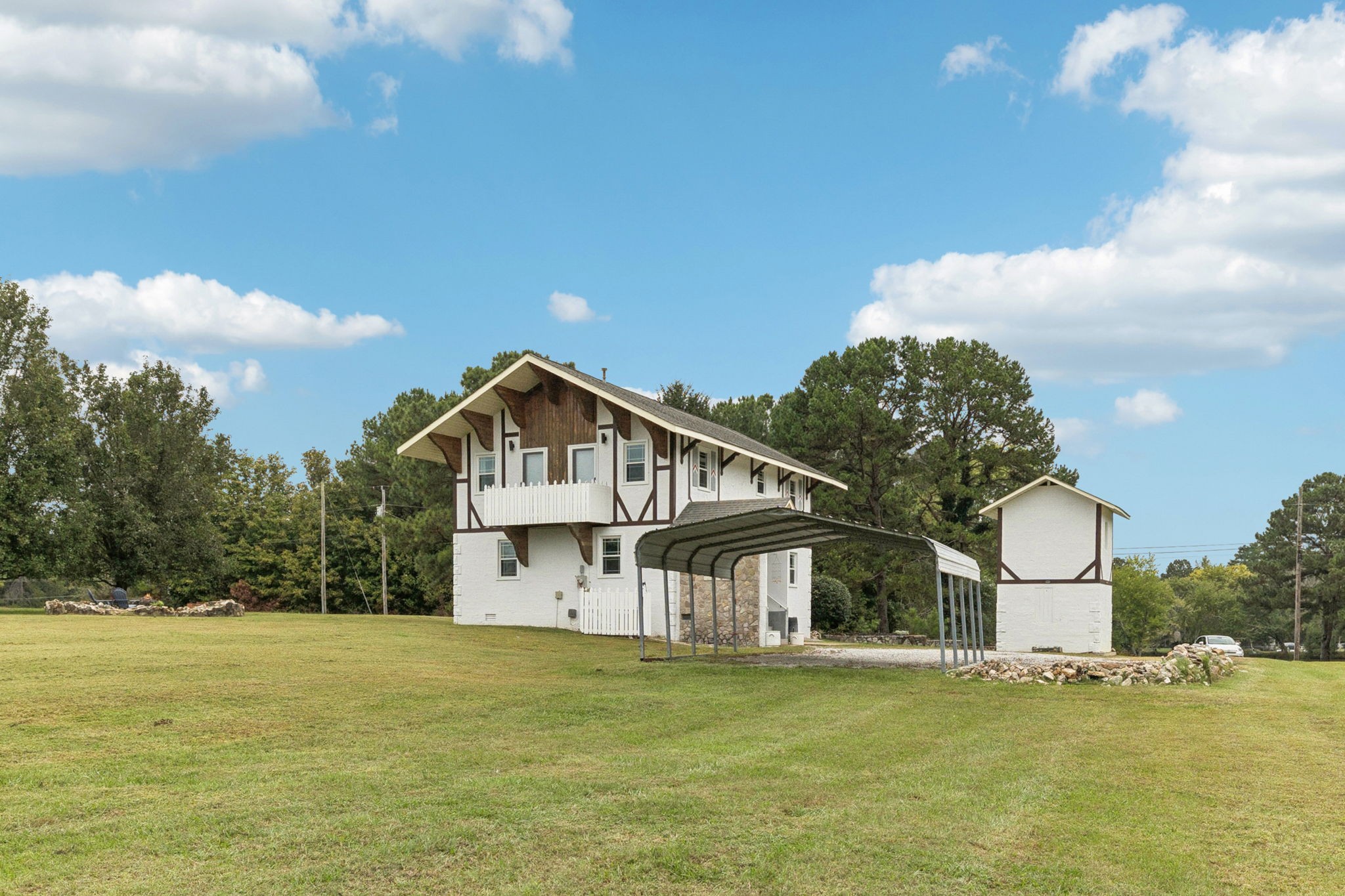 106 Highland Street Hohenwald, TN 38462 - Photo 55 of 85 a front view of a house with a garden and lake view
