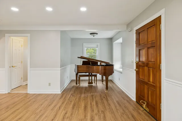 a view of empty room with wooden floor and furniture