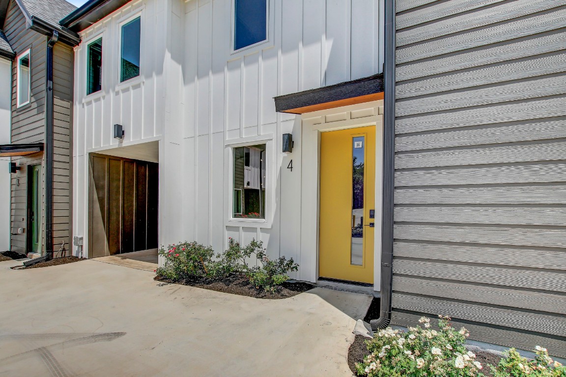 4127 East 12th Street, Unit 4 Austin, TX 78721 - Photo 29 of 32 Property entrance with board and batten siding and a patio