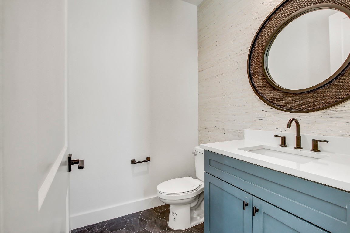4127 East 12th Street, Unit 4 Austin, TX 78721 - Photo 9 of 32 Bathroom featuring vanity, tile patterned flooring, toilet, and baseboards