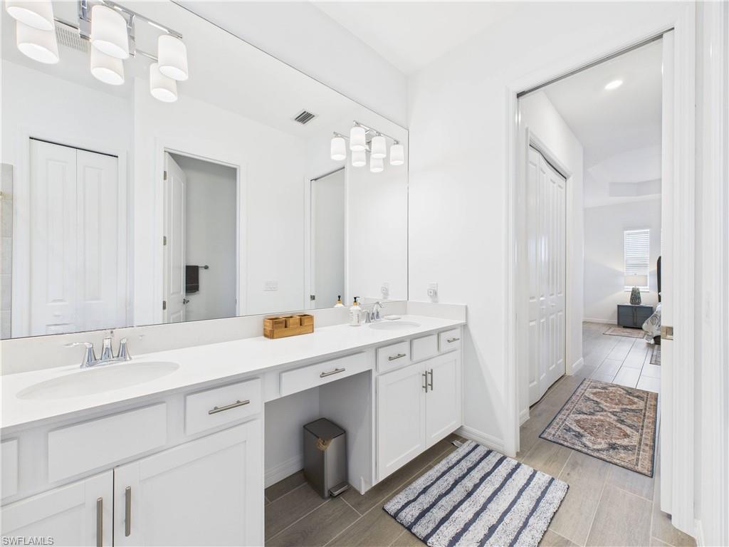 5412 Fancourt Links Way Ave Maria, FL 34142 - Photo 18 of 39 Full bath with wood finish floors, double vanity, and a closet