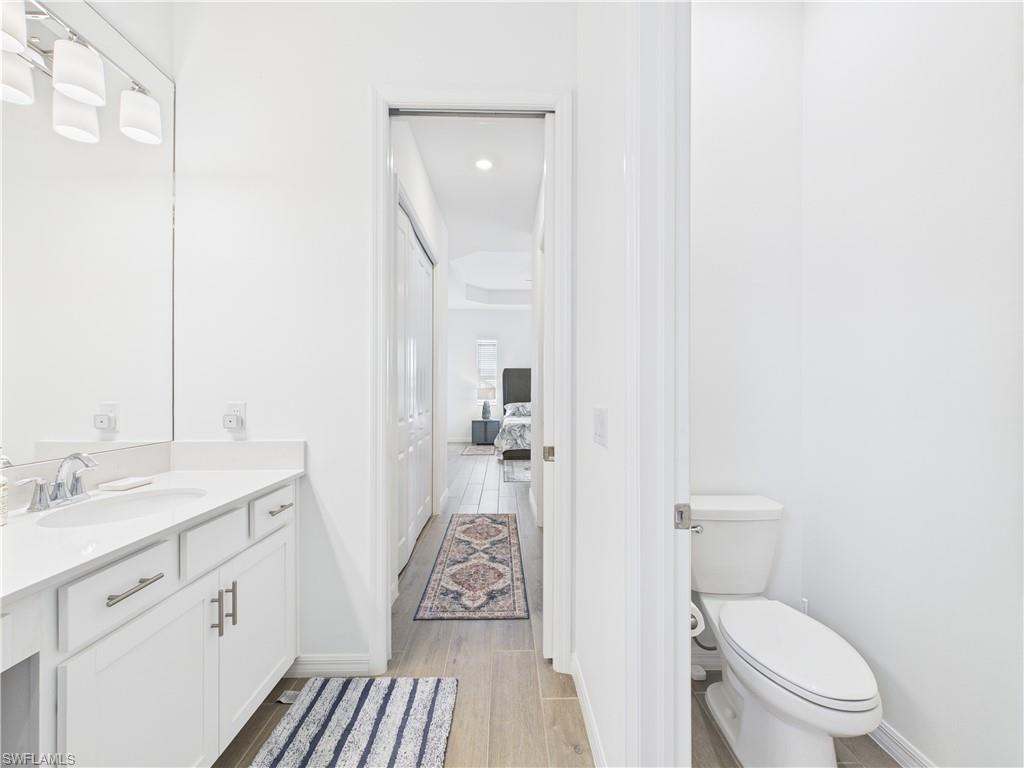 5412 Fancourt Links Way Ave Maria, FL 34142 - Photo 20 of 39 Bathroom with light wood-style floors, vanity, recessed lighting, and ensuite bath