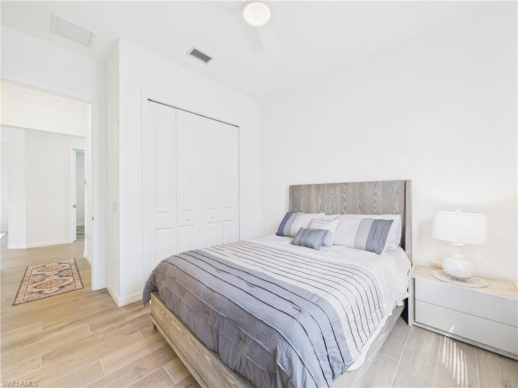 5412 Fancourt Links Way Ave Maria, FL 34142 - Photo 24 of 39 Bedroom featuring a closet, light wood finished floors, and ceiling fan