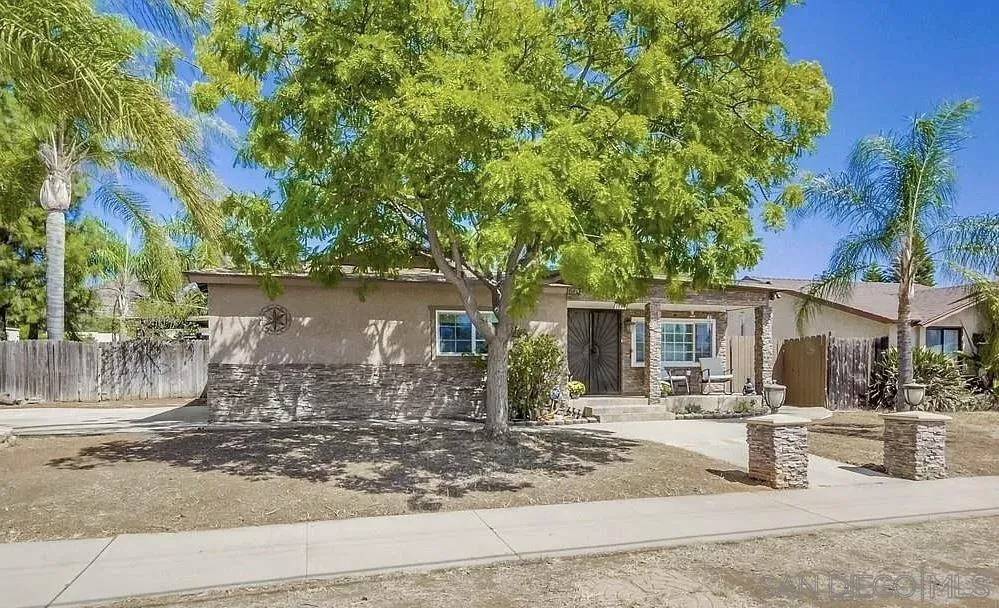 a front view of a house with yard tree s