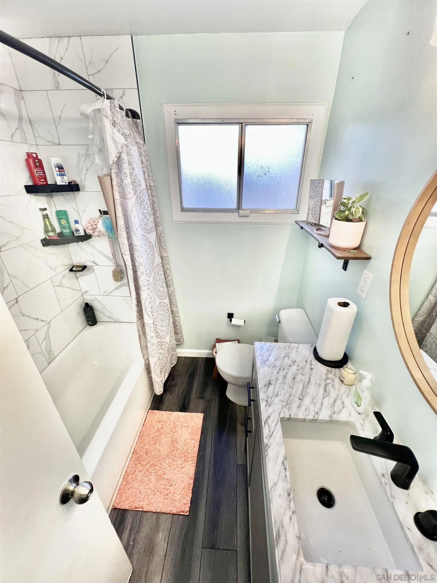 1663 Buckeye Drive El Cajon, CA 92021 - Photo 11 of 20 a bathroom with a sink and mirror with bathtub