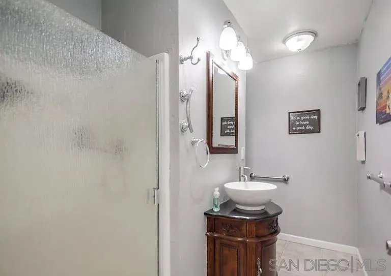 1663 Buckeye Drive El Cajon, CA 92021 - Photo 15 of 20 a bathroom with a sink a light fixture and a mirror