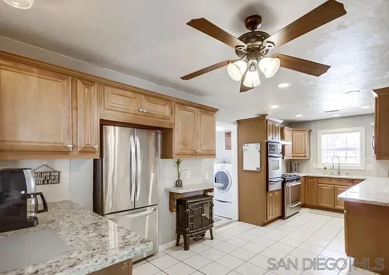 1663 Buckeye Drive El Cajon, CA 92021 - Photo 9 of 20 a kitchen with refrigerator and cabinets