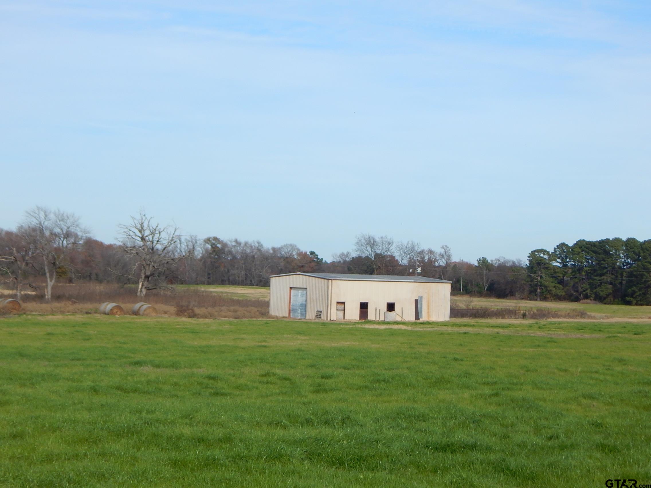 74 Acres Elderberry Road Gilmer, TX 75644 - Photo 1 of 16 a house with river in front of it
