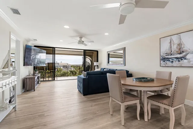 a living room with a balcony furniture and a flat screen tv