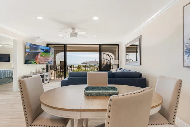 a bedroom with a bed and a table in it with a large window