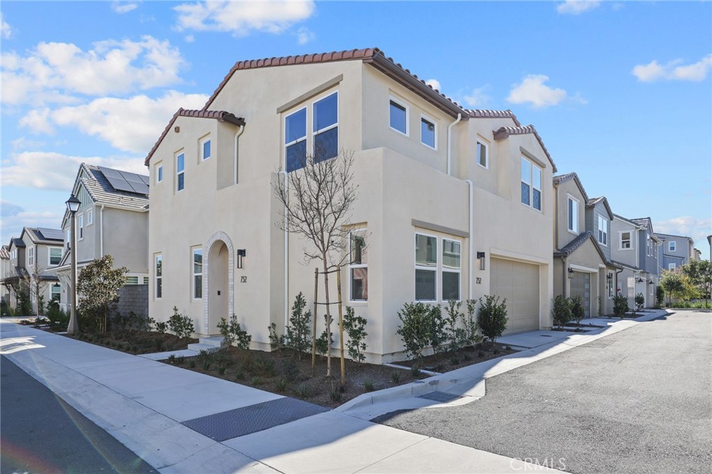 732 Jasper Street Rancho Mission Viejo, CA 92694 - Photo 1 of 28 a view of a white building among the street with palm trees