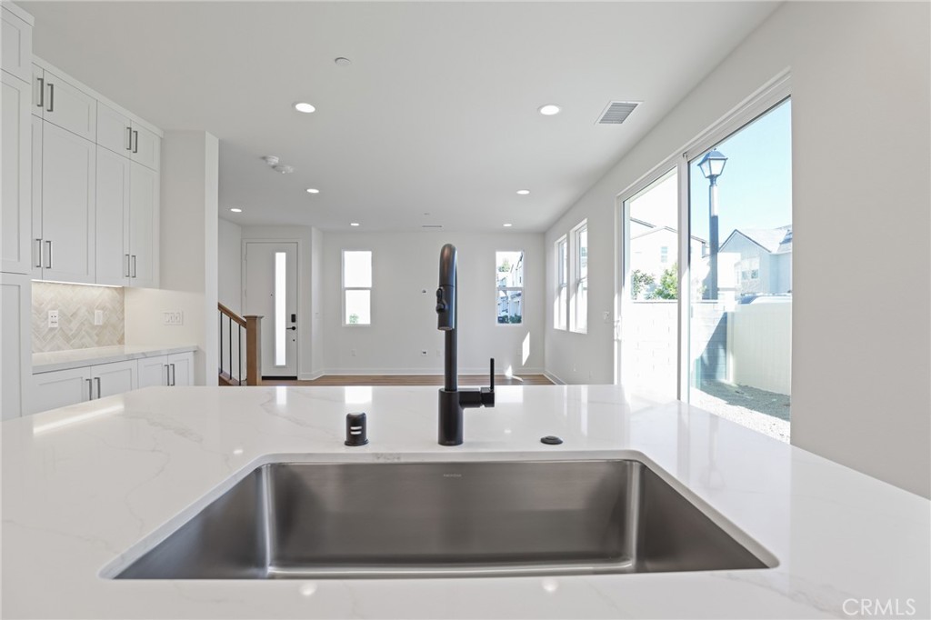 732 Jasper Street Rancho Mission Viejo, CA 92694 - Photo 12 of 28 a view of kitchen with kitchen island a sink and counter space