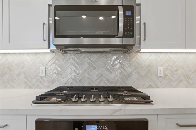 a close view of a stove a microwave and door