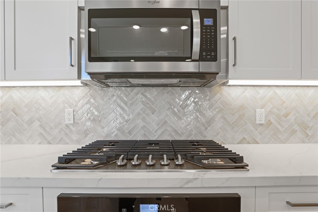 732 Jasper Street Rancho Mission Viejo, CA 92694 - Photo 13 of 28 a close view of a stove a microwave and door