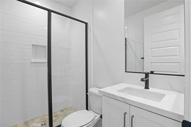 a bathroom with a sink a toilet and mirror