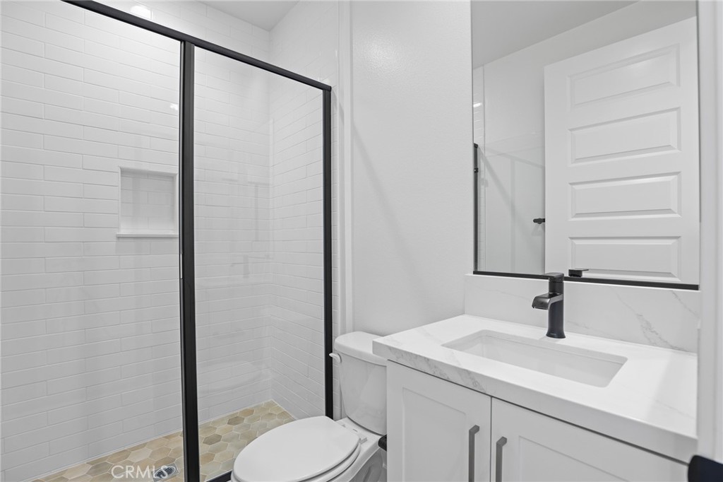 732 Jasper Street Rancho Mission Viejo, CA 92694 - Photo 15 of 28 a bathroom with a sink a toilet and mirror