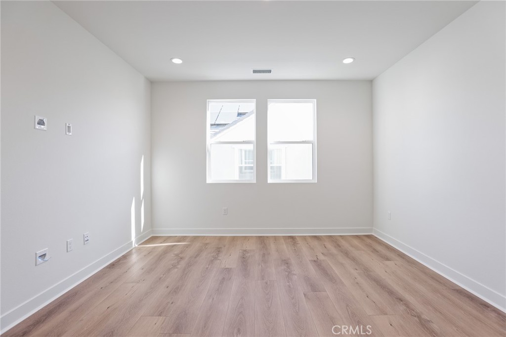 732 Jasper Street Rancho Mission Viejo, CA 92694 - Photo 18 of 28 an empty room with wooden floor and windows