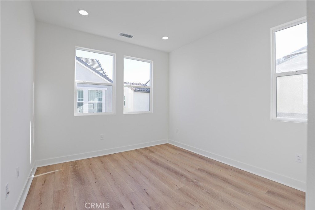 732 Jasper Street Rancho Mission Viejo, CA 92694 - Photo 23 of 28 an empty room with wooden floor and windows