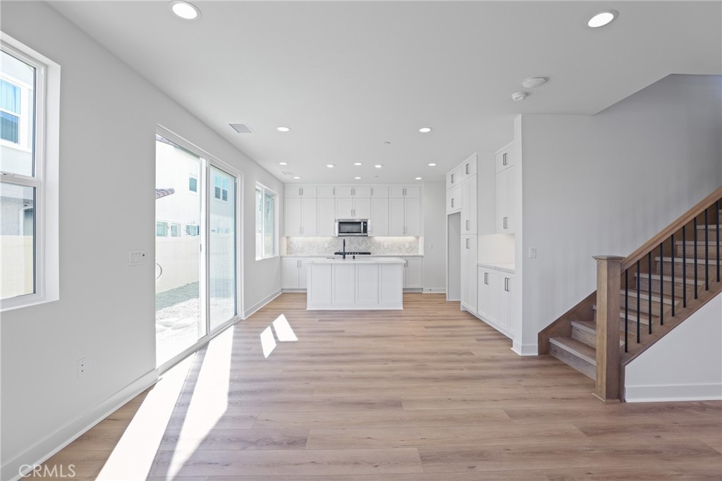732 Jasper Street Rancho Mission Viejo, CA 92694 - Photo 3 of 28 a view of a kitchen with wooden floor and windows