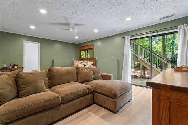 a bedroom with a large bed and a flat tv screen on dresser