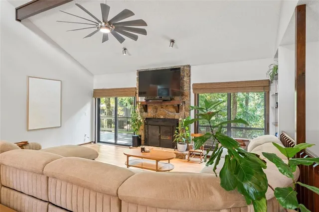 a bedroom with a bed and large windows