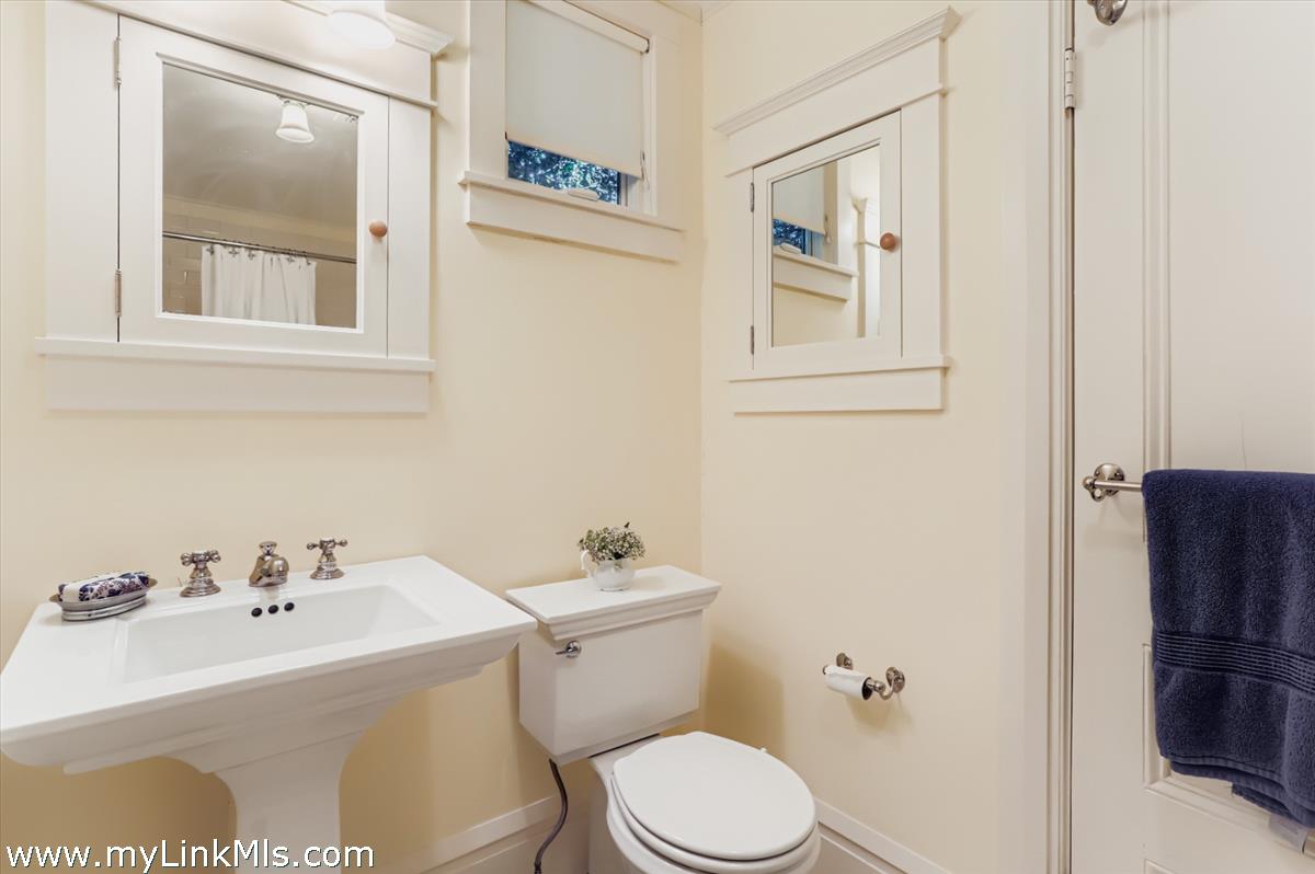 27 Spring Street Vineyard Haven, MA 02568 - Photo 36 of 58 a bathroom with a sink mirror and toilet