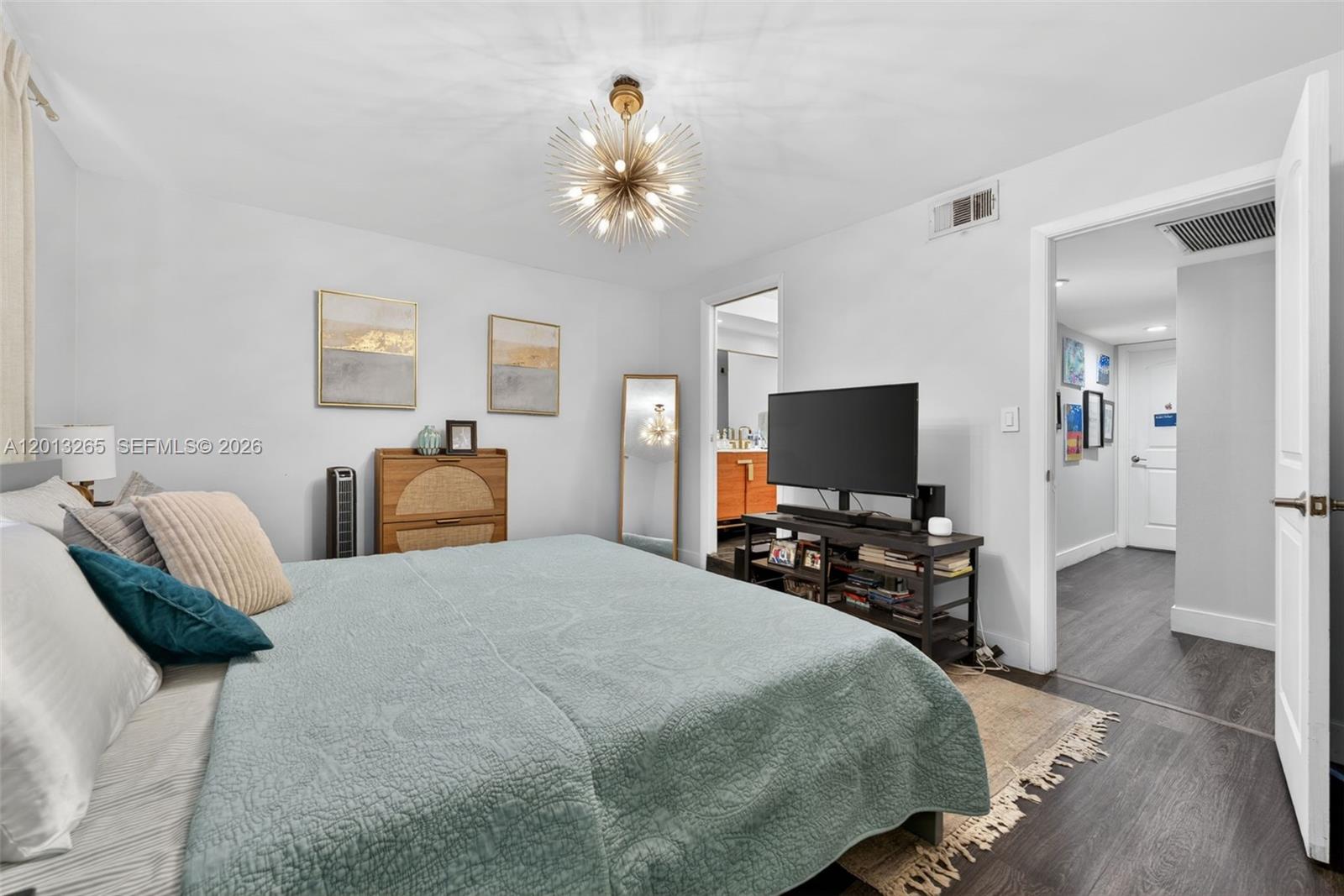 13189 Southwest 9th Lane Miami, FL 33184 - Photo 11 of 24 a bedroom with a bed and a flat screen tv
