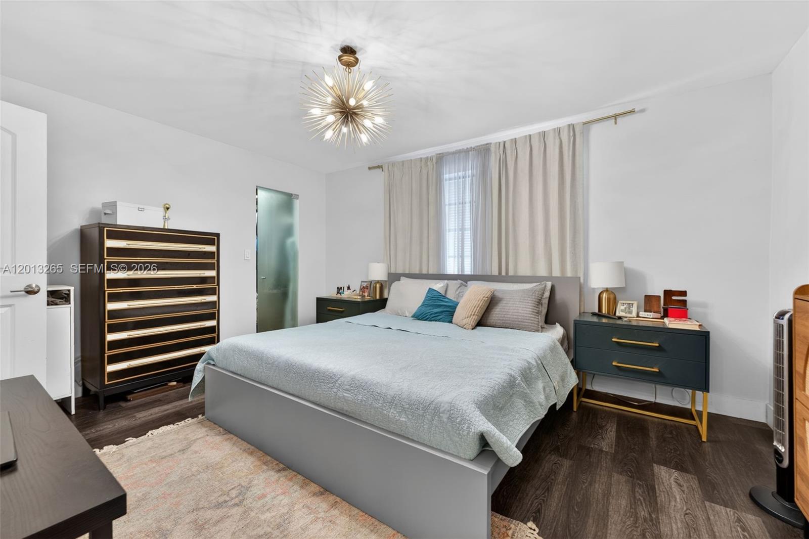 13189 Southwest 9th Lane Miami, FL 33184 - Photo 12 of 24 a bedroom with a bed wooden floor and lamp on desk