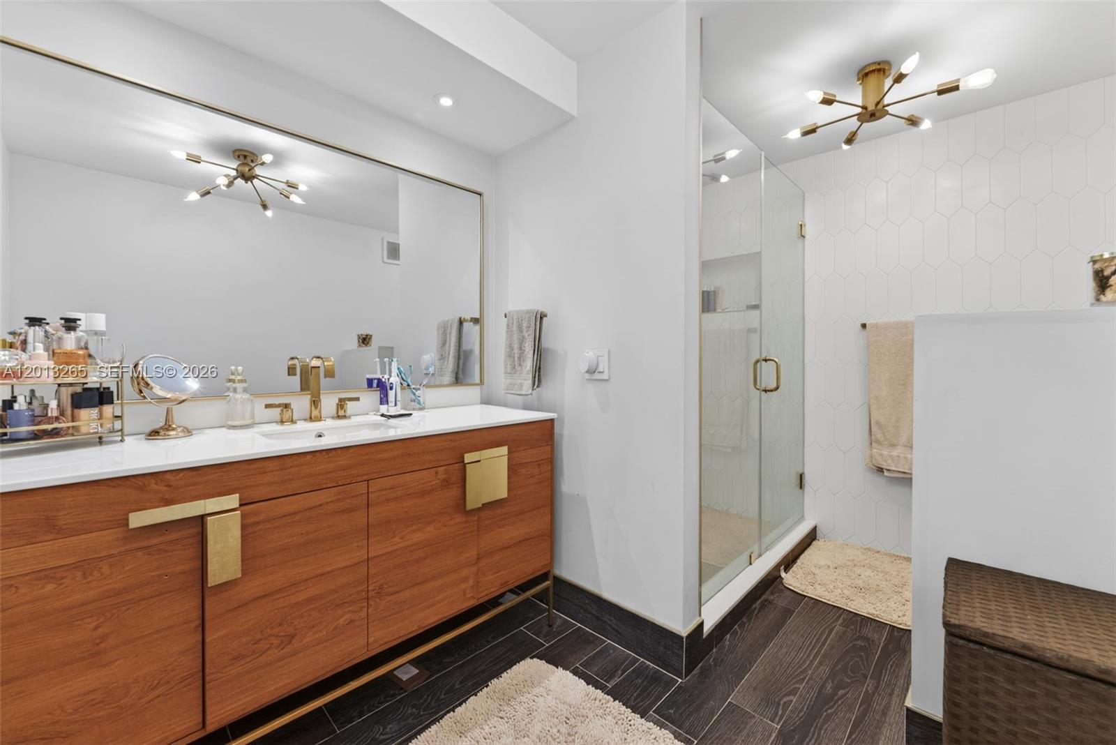 13189 Southwest 9th Lane Miami, FL 33184 - Photo 13 of 24 a bathroom with a sink mirror and a shower