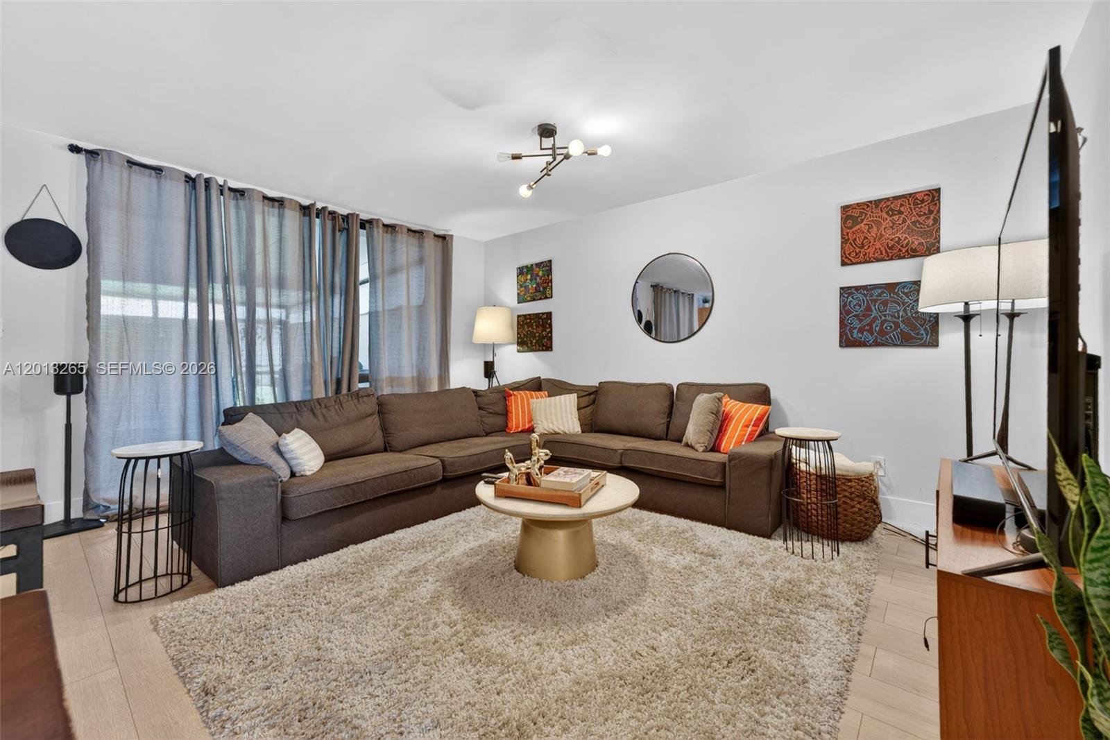 13189 Southwest 9th Lane Miami, FL 33184 - Photo 10 of 24 a living room with furniture and a flat screen tv