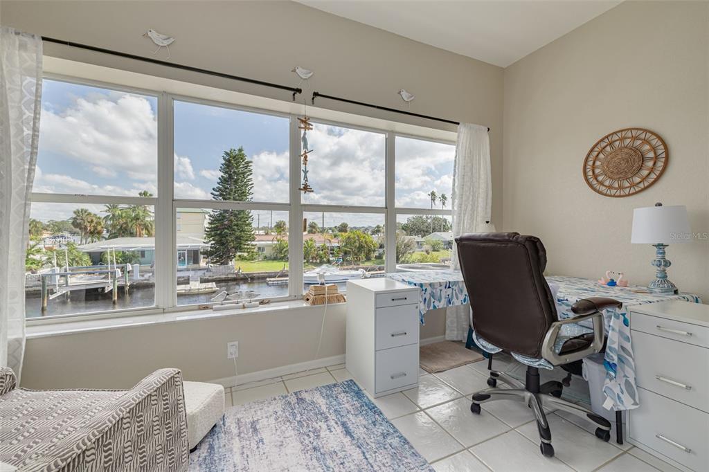 8246 Aquila Street Port Richey, FL 34668 - Photo 18 of 43 a dining room with wooden floor and a window