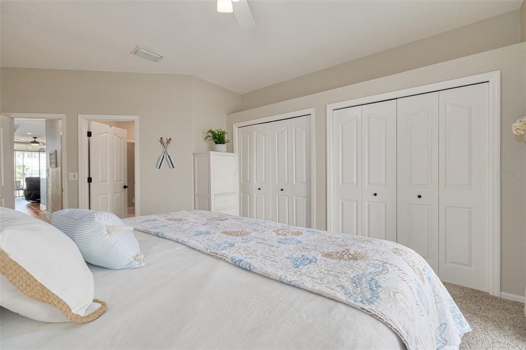 8246 Aquila Street Port Richey, FL 34668 - Photo 20 of 43 a spacious bedroom with a bed and a mirror